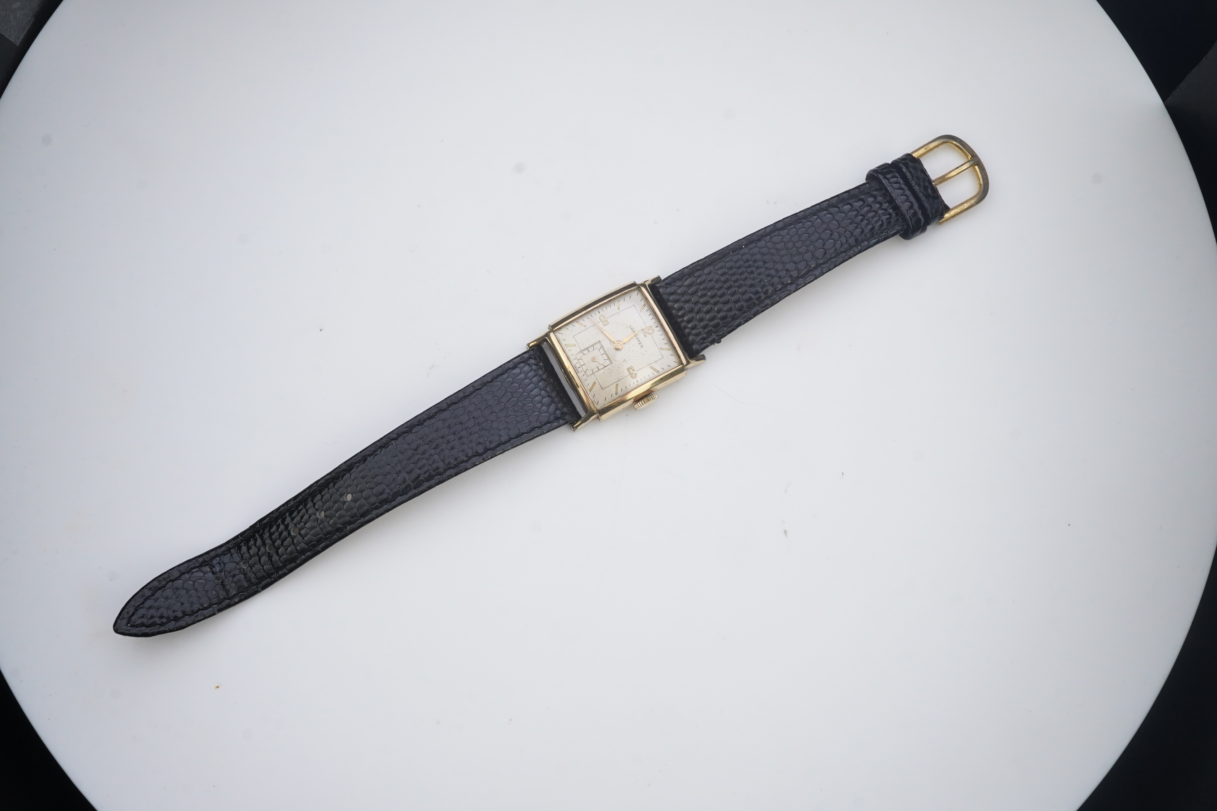 A gentleman's late 1940's gold plated Longines manual wind wrist watch, on a later associated leather strap